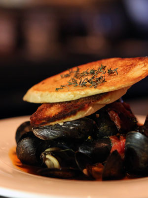 elegantly-plated P.E.I. mussel clams topped with bread